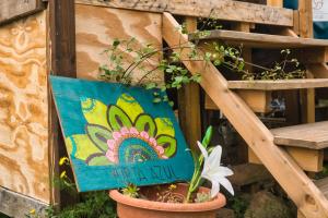 a pot with a painting of a flower on it at La Muntanera - Eco Yurt - Pool, Nature retreat in Figuerola