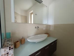 a bathroom with a white sink and a mirror at IseoLakeRental - La Dolce Vista in Riva di Solto
