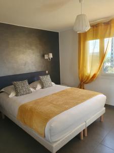 a bedroom with a large bed with a window at Le Mas des Quintrands Manosque - Motel de charme in Manosque +60 photos