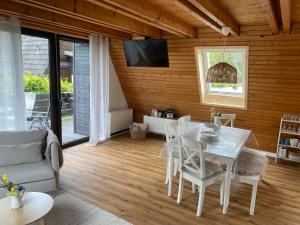 a living room with a white table and chairs at Ferienhaus am See im Fichtelgebirge in Nagel