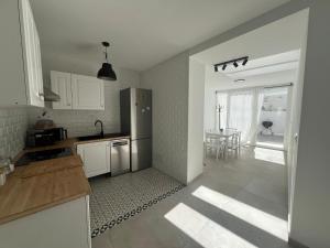 a kitchen with a stainless steel refrigerator and a table at Casa Azul in Vélez Blanco