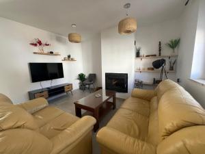 a living room with two couches and a flat screen tv at Casa Azul in Vélez Blanco