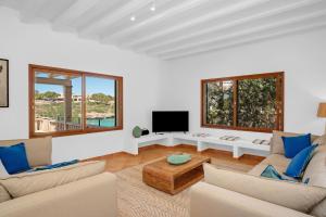 a living room with two couches and a tv at LA CITA DEL MAR Cala Marsal Luxury SEA experience in Portocolom