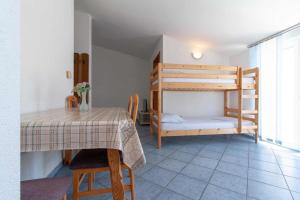 a room with a table and a bunk bed at Villa Raguž sa Privatnom plažom i Garažom in Neum
