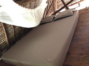 a mattress on the floor of a room at Beach front Cottage in Mahambo