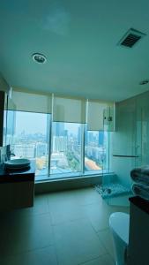 a large bathroom with a view of a city at The H Tower Rasuna Suites Kuningan jakarta by Villaloka in Jakarta