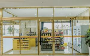 a store with glass doors and a grocery store at Pearly Hotel in Jeju