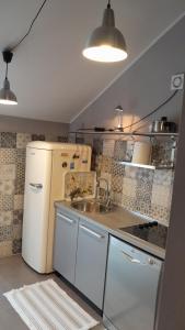 a kitchen with a white refrigerator and a sink at Apartments Dakovic in Kotor