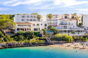 a view of a beach with white buildings at LA CITA DEL MAR Cala Marsal Luxury SEA experience in Portocolom
