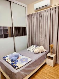 a bed with two pillows on it in a room at Idea Homestay 3 in Chemor