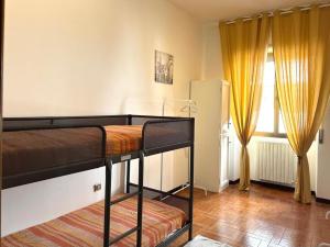 a bedroom with two bunk beds and a window at Appartamento TD in Follonica