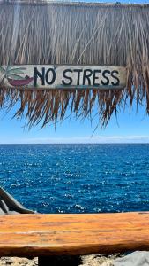 un cartello che dice niente stress seduto su una panchina vicino all'acqua di Salento Villa Don Peppino a San Foca