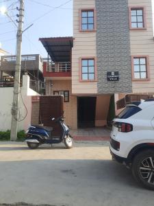 a motor scooter parked in front of a building at Ganpati Villa in Dehradun