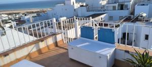 a balcony with a view of the ocean and buildings at Duplex ático con las mejores vistas de Conil in Conil de la Frontera