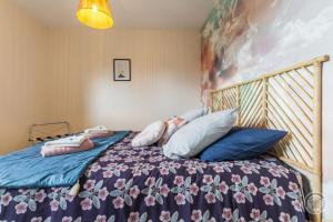 a bedroom with a bed with pillows on it at La Suretière in Montmartin-sur-Mer