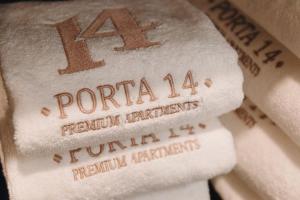 a pile of white towels with the name of a book at Apartamento Porta14 2 in Chaves