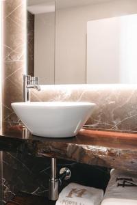 a white sink on a counter in a bathroom at Apartamento Porta14 2 in Chaves