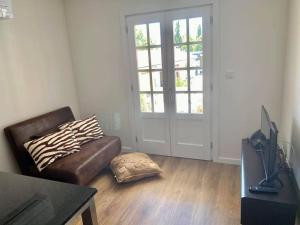 a living room with a couch and a ottoman at Apartamento Porta14 2 in Chaves