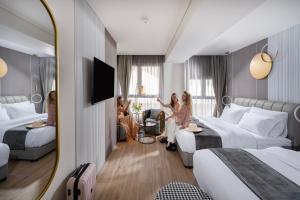 two women are standing in a hotel room at Allenbeach TLV- Adults only - WE HAVE SHELTER in Tel Aviv