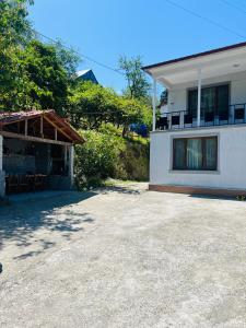a house with a large driveway next to a building at your house in batumi in Batumi