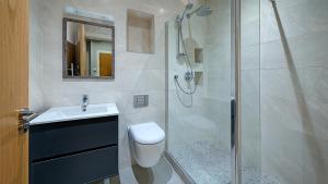 a bathroom with a shower and a toilet and a sink at Kilmurry Lodge Hotel in Limerick