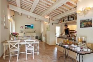 a kitchen with a table and chairs in a room at Pamperduto Country Resort in Porto Potenza Picena