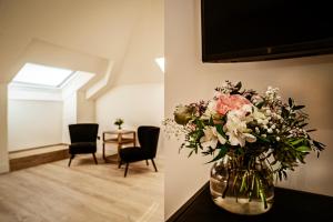 a vase of flowers sitting on a table in a room at Hotel Cigarral Santa María in Toledo
