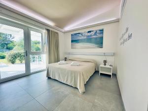 Кровать или кровати в номере 309 Le Saline - Stintino