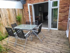 a glass table and chairs on a patio at Charming 2-Bed Apartment in Birmingham in Birmingham