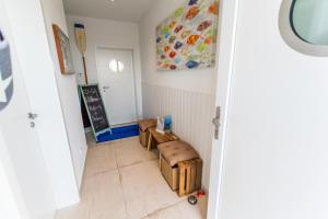 a small room with a chalkboard and a table and stool at Haus Seaside-Dahme in Dahme