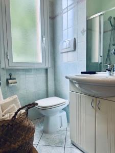 a bathroom with a toilet and a sink at Hotel San Giorgio in Albisola Superiore
