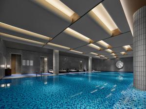 a pool in a building with a swimming pool at Banyan Tree Suzhou Shishan in Suzhou