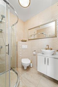a bathroom with a toilet and a sink and a shower at Adore in Palanga