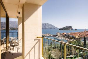 a balcony with a view of a harbor at Merit Starlit Hotel & Residences in Budva
