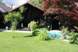 een huis met een tuin met een zwembad ervoor bij Frenk cottage 5 KM FROM THE AIRPORT-free transportation in Šenčur