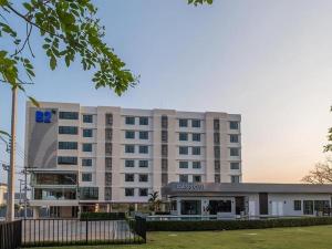 a large white building with a hospital at B2 Korat Premier Hotel in Ban Liap