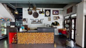 a restaurant with a counter in a room at Hometel Hotel in Krabi