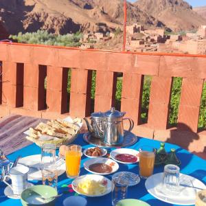 a table with food and a tea pot on it at Gorges View Dades in Tamellalt