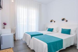 Postel nebo postele na pokoji v ubytování Hostal La Isla