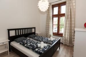 a bedroom with a bed and a large window at Apartment Diana in Košice