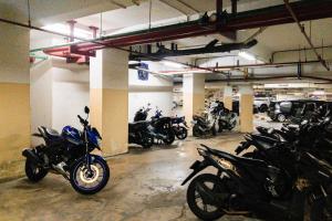 a garage with a bunch of motorcycles parked in it at Pelangi Rooms By Reccoma in Pondokcabe Hilir