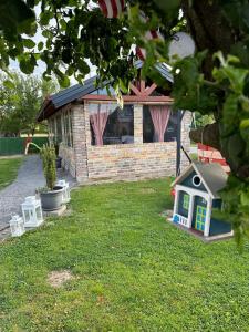a toy house in the yard of a house at Holiday Home TimeOut Bizovac in Bizovac