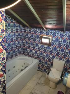a bathroom with a tub and a toilet at Bahaus Resort in Dalyan