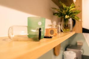 a counter with a green appliance on a wooden shelf at Susu'home - Căn hộ view biển - Trung tâm Bãi Cháy in Ha Long