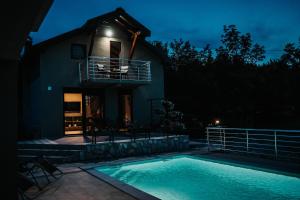 a house with a swimming pool at night at Kuća za odmor Mihaela in Široki Brijeg