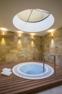 a jacuzzi tub in a room with a large ceiling at ARC Recoleta Boutique Hotel & Spa in Buenos Aires