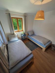 a bedroom with two beds and a window at Ferienwohnung Elisabeth in Bischofswiesen +9 photos