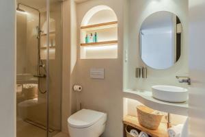 a bathroom with a toilet and a sink and a mirror at Apartamentos Azul in Castelldefels +67 photos
