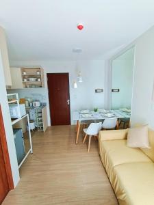 a living room with a couch and a table at The Hive tower D with pool, Wifi, and balcony in Taytay
