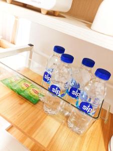 a group of bottles of bottled water in a refrigerator at The Hive tower D with pool, Wifi, and balcony in Taytay